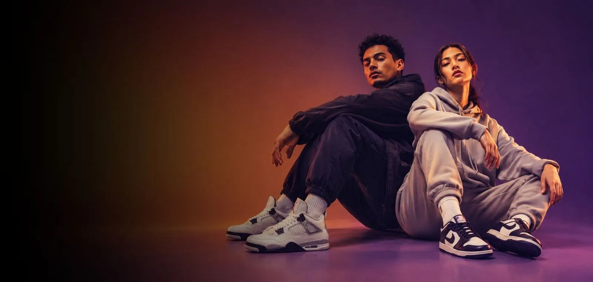Man and woman wearing sneakers in a studio campaign setting